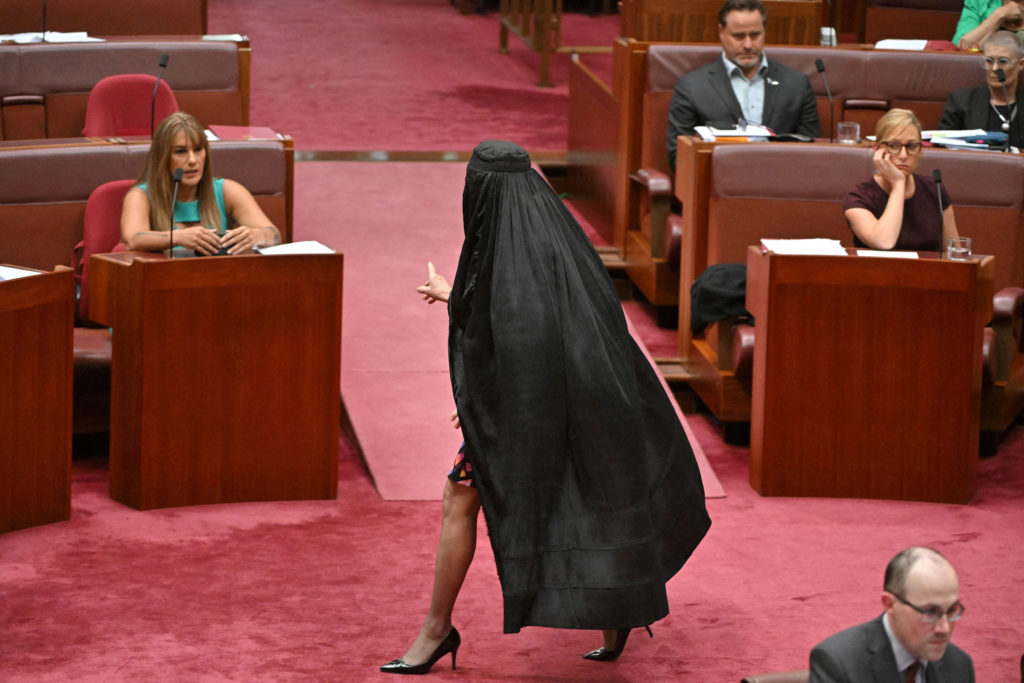 Far-right Australian senator suspended after entering Parliament in a burqa during protest